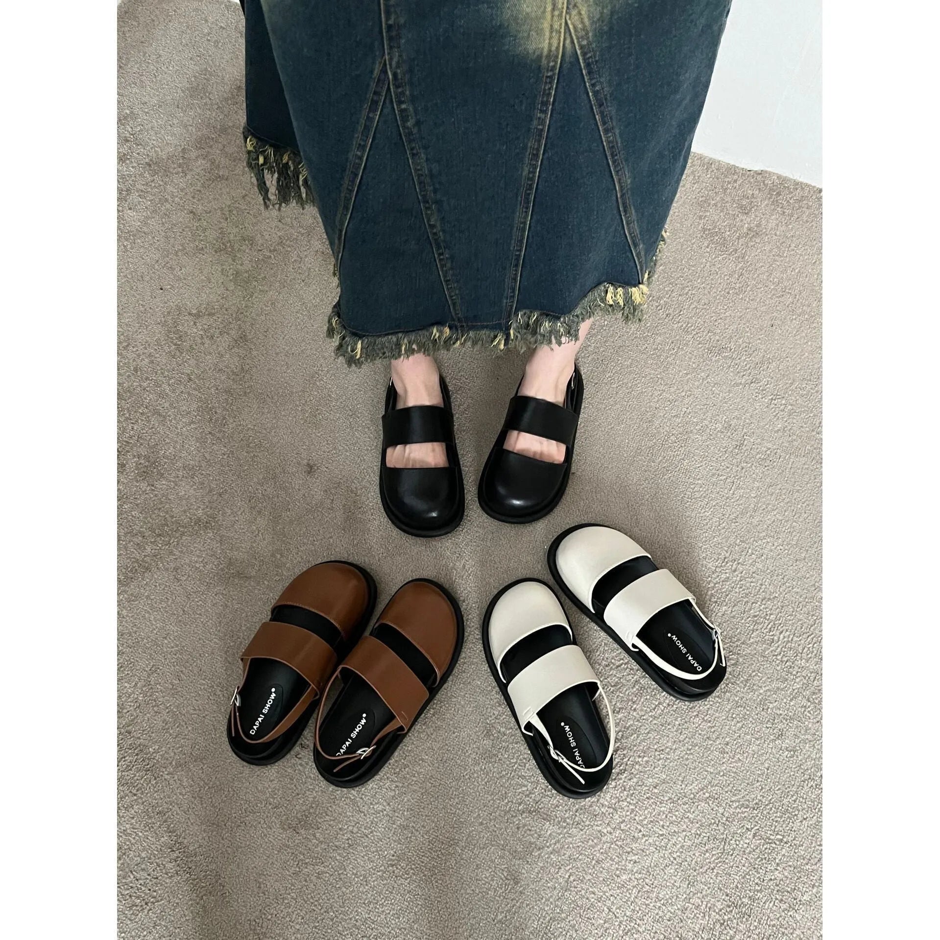Korean style women's retro sandals with a black microfiber upper and adjustable ankle buckle on a PVC sole.
