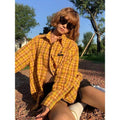 Dopamine Yellow loose fit plaid shirt for men and women on a hanger.