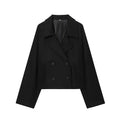 Short double breasted woolen coat in black with front pockets on a woman for commute wear