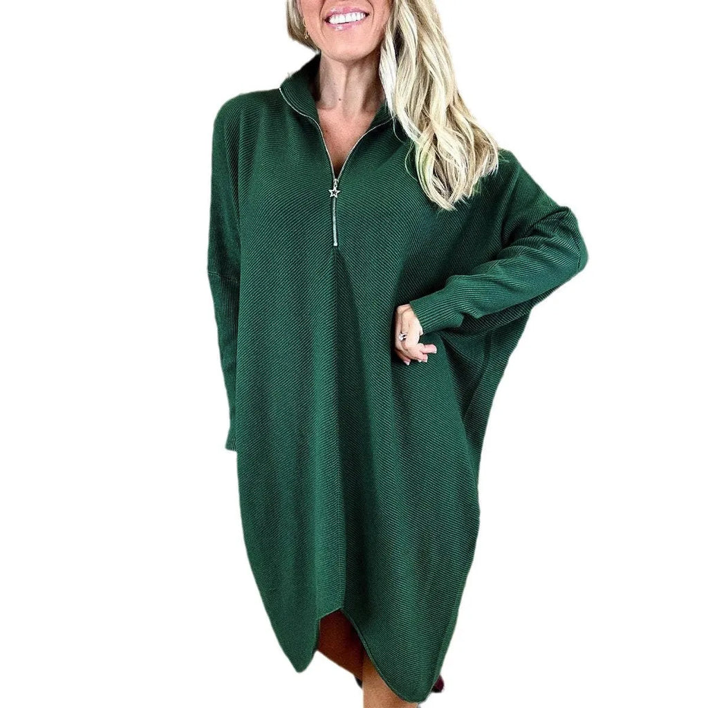 Women's solid colour loose fit knitted dress with raglan sleeves on a hanger.