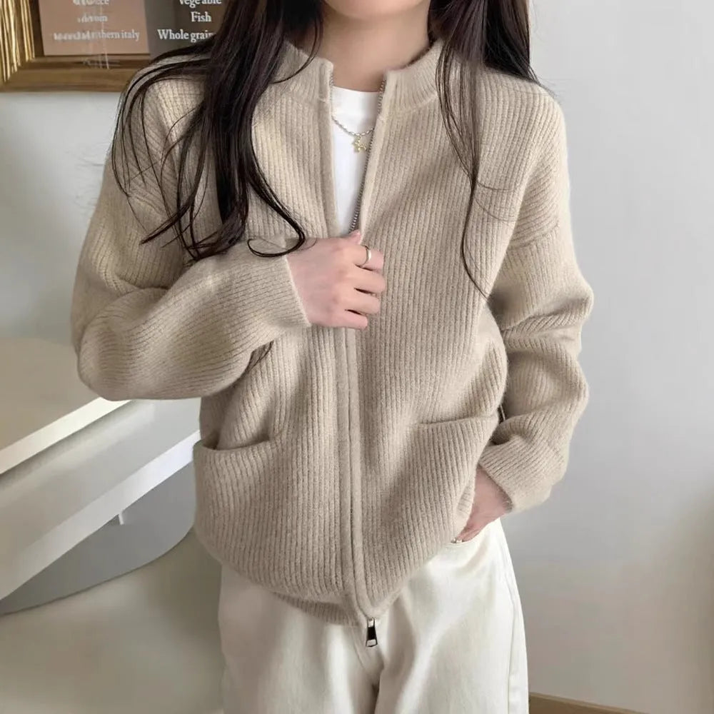 Beige temperature-sensitive viscose sweater coat, long sleeve cardigan style on a hanger.
