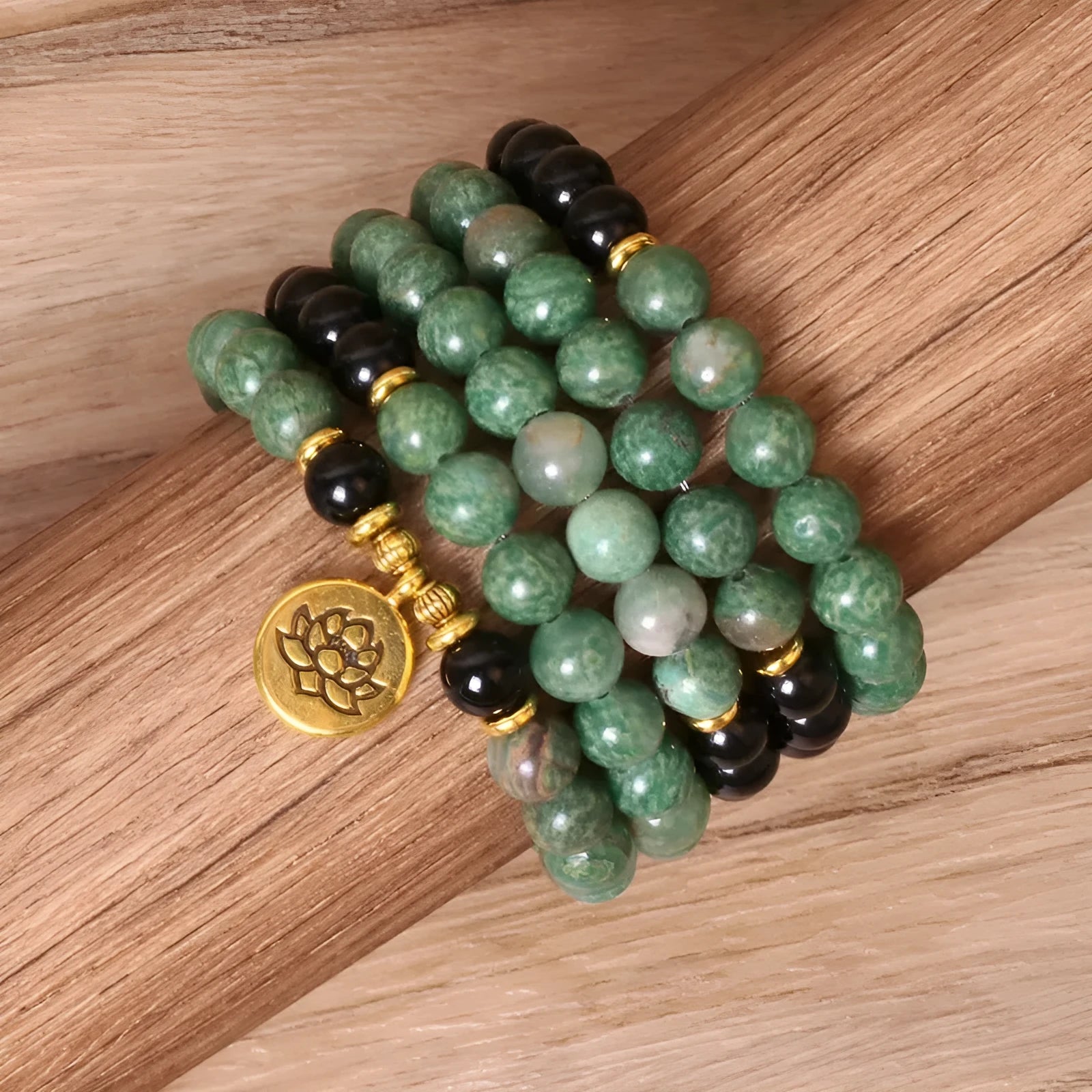 Green and black alloy elastic beaded long bracelet on a wrist, showing natural style design.