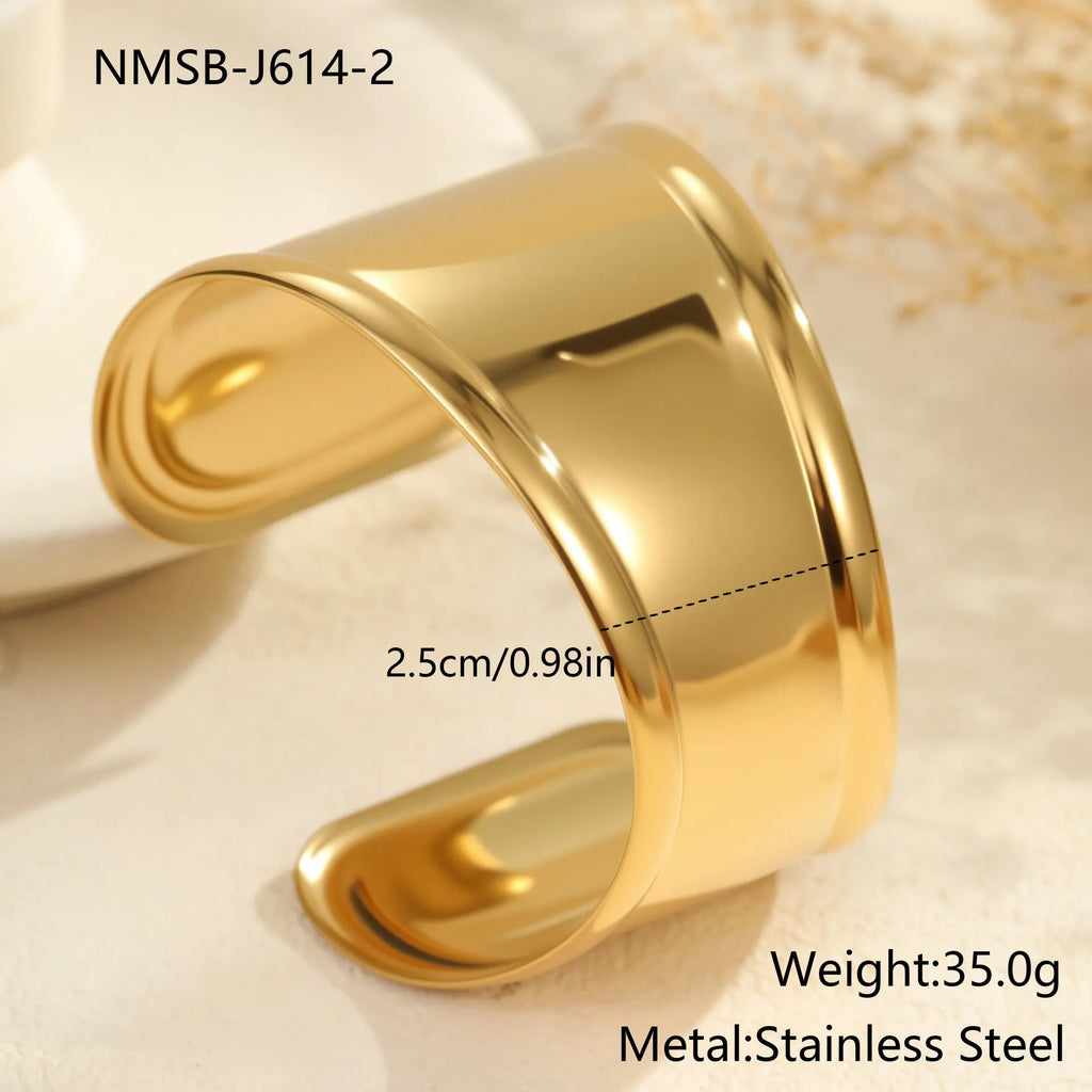Women's wide geometric wave bracelet with gold plating and niche opening detail on wrist