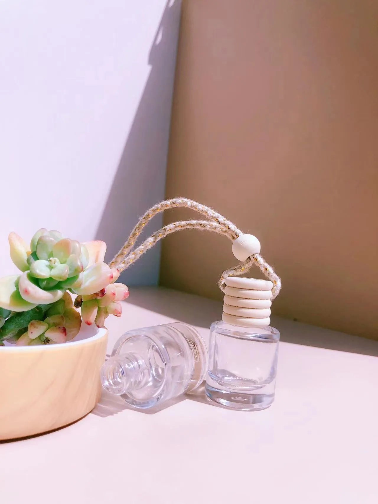 Glass car perfume pendant fragrance diffuser in cylinder, diamond, flat drum, and square styles.