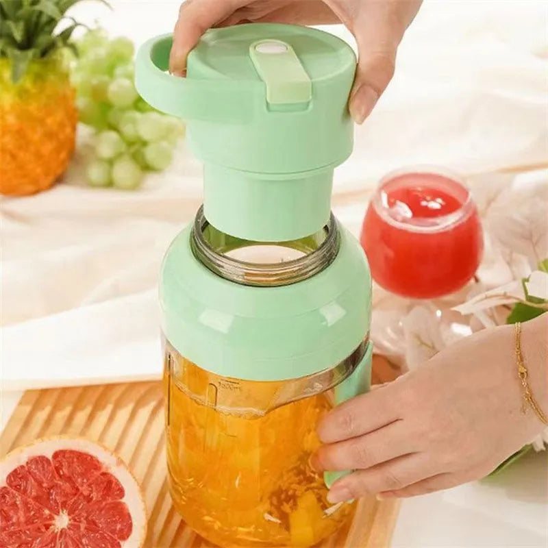 Portable 1500ml electric juicer with double handles and USB charging cable in emerald green