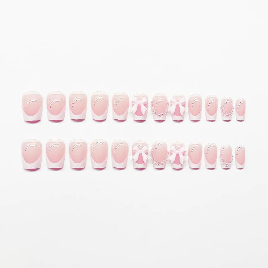 Set of 24 short French manicure false nails with white tips, bow designs, tulip patterns, and leopard print on a European square shape.