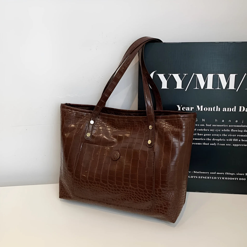 Retro large capacity single-shoulder handbag in brown, soft PU material with stitching detail, horizontal square shape.