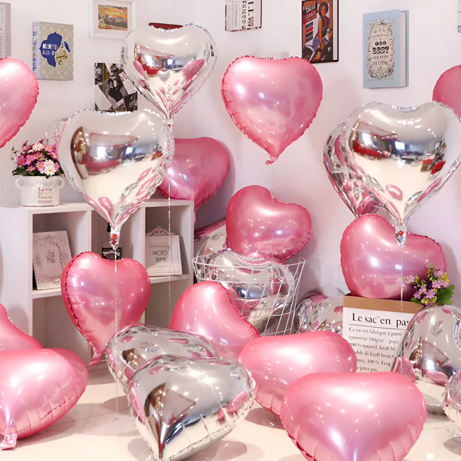 Five peach-shaped heart balloons made from crinkled silver aluminium foil, held together on strings.