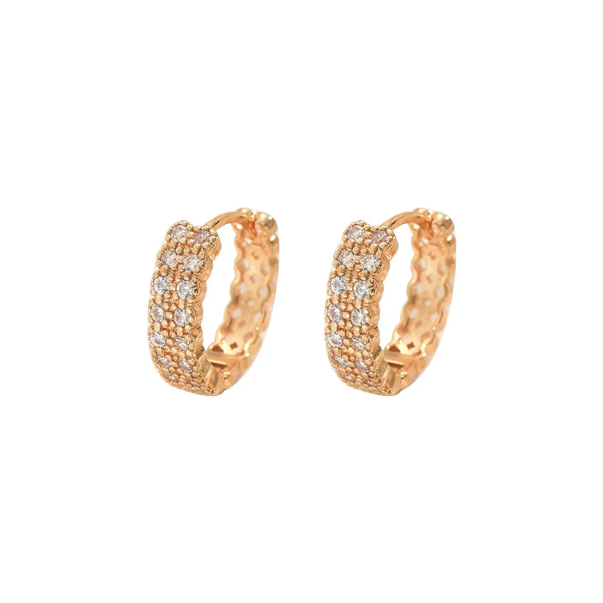 A pair of women's geometric pattern ear studs made from copper, showing round, dot, and ring design details.