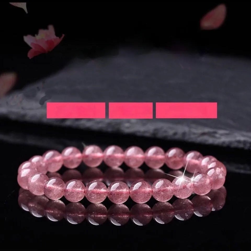 Women's strawberry quartz crystal bracelet with polished beads in 6mm, 8mm, or 10mm diameter options
