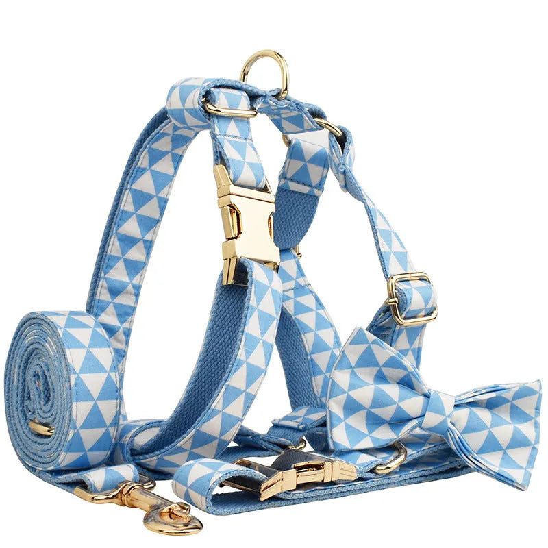 Blue cloth dog vest set with matching collar, leash, and bow tie on a white background