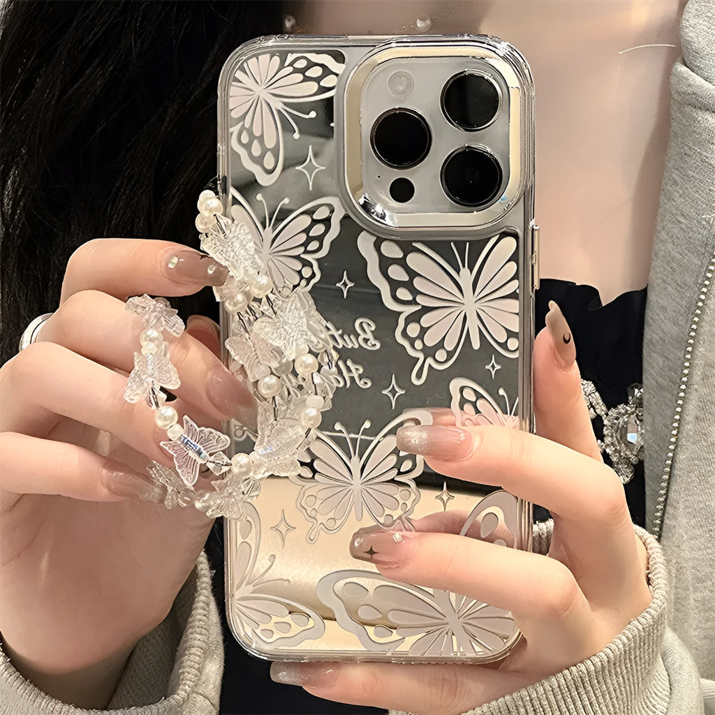 Transparent iPhone case with a built-in round mirror and a painted pink bow decoration on the back.