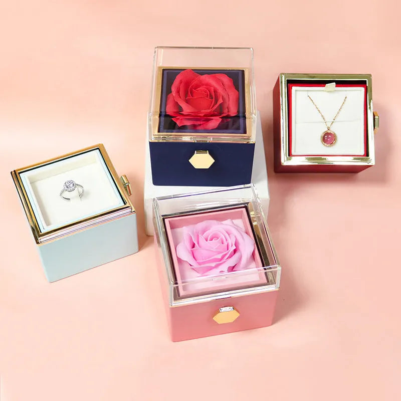 Rotating jewellery gift box with a preserved red rose under a clear acrylic dome.