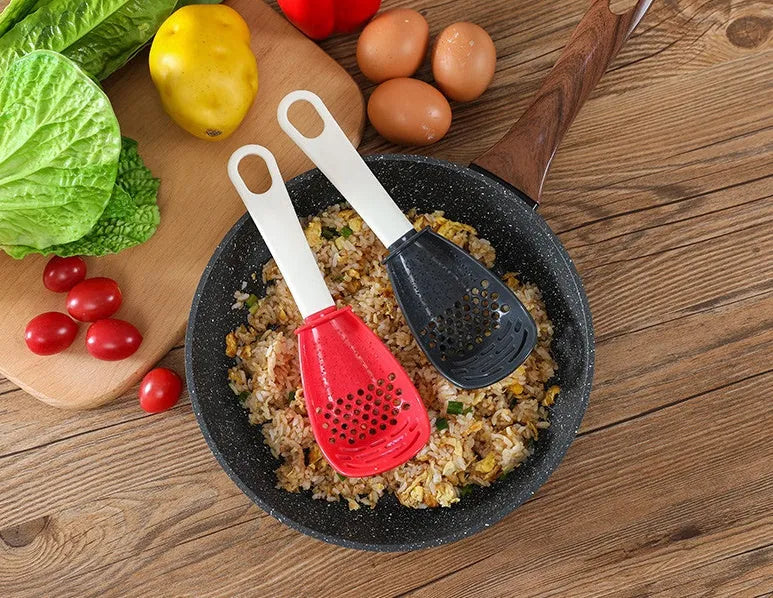 Red and black plastic multifunctional slotted cooking spoon with serrated edges for mashing and grinding.