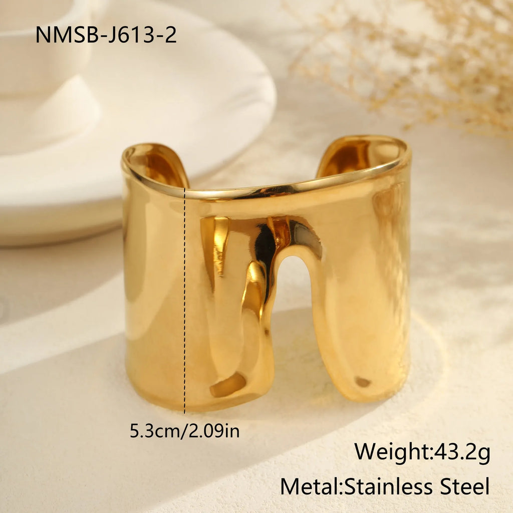 Women's gold plated stainless steel bracelet with geometric wave design and exaggerated width