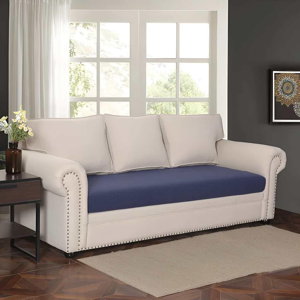 Waterproof corduroy sofa cover in beige with anti-slip elastic edges on a two-seater sofa in a living room