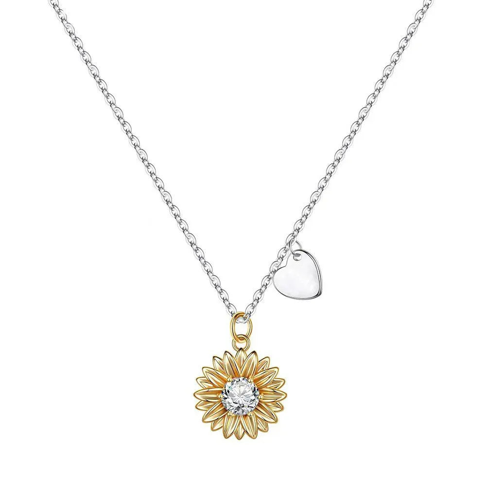 Silver sunflower necklace with geometric pendant and cross chain on a model.