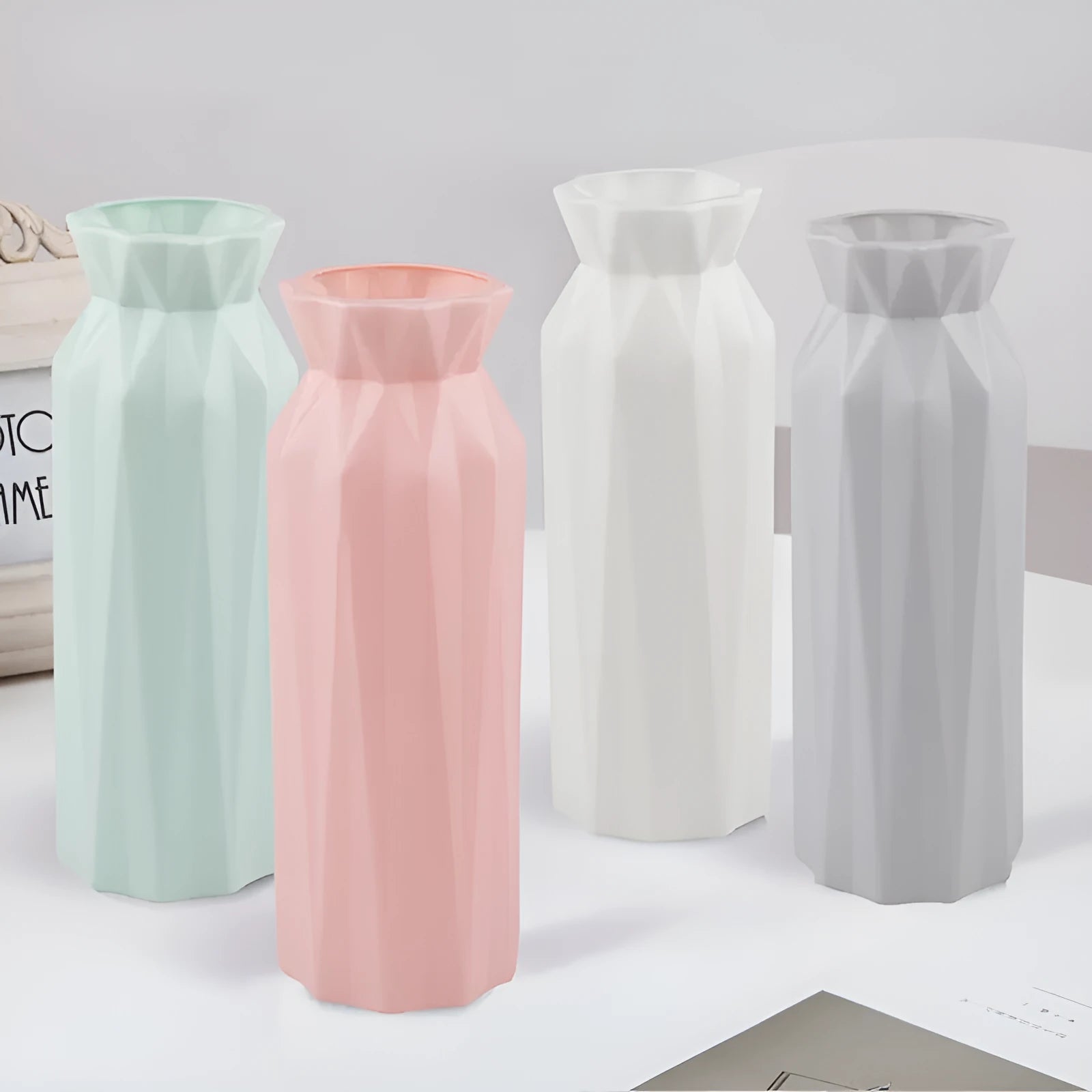 Drop-resistant plastic melamine vase in green, grey, pink, or white colour on a table.