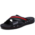 Men's white cowhide leather flip-flops with a non-slip PU sole on a sandy beach.