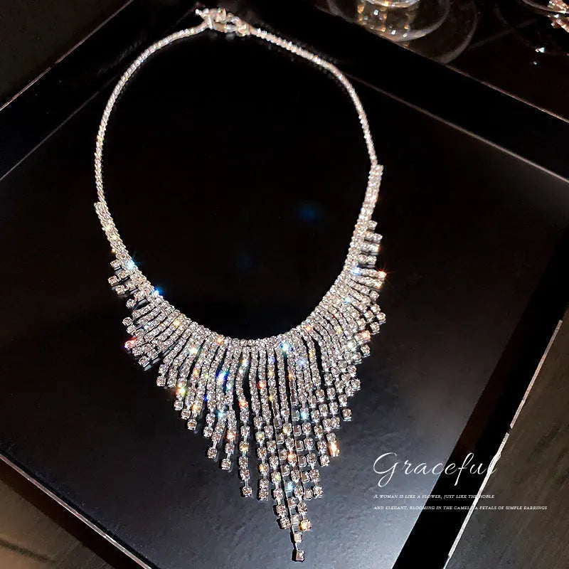 Silver diamond tassel necklace with geometric alloy pendant and ball bead chain on a light background