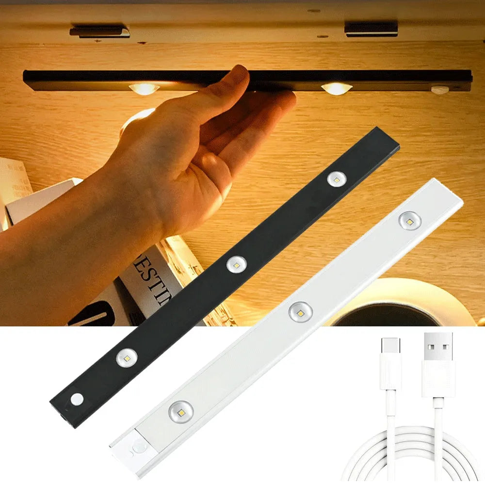 Silver ultra-thin wireless LED strip light with motion sensor attached to a kitchen cabinet door.