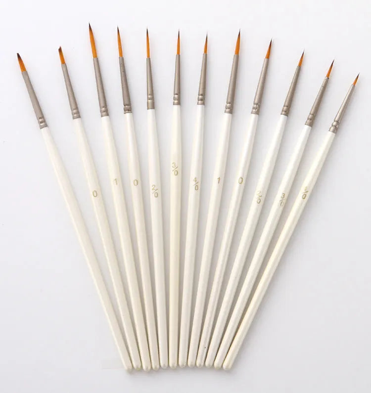 Set of 12 pearl white artists' brushes in a solid wood holder, sizes from 0 to 4/0 for watercolour and acrylic painting.