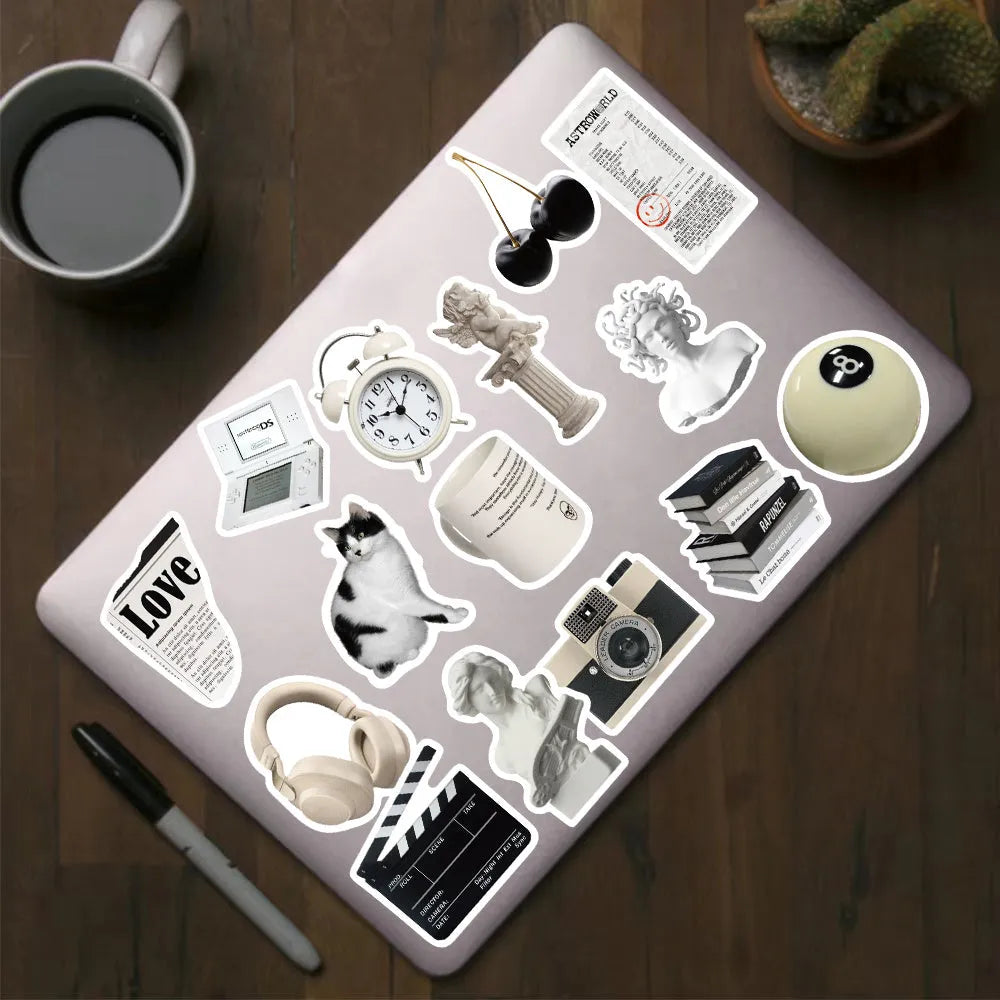 61 black and white waterproof PVC stickers for laptops, phones, and luggage decor.