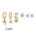 Gold and silver flower-shaped ear studs with zircon mosaic detail on a white background.