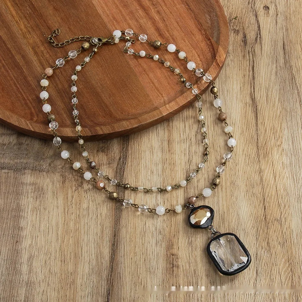 Two-layer tribal necklace with glass pendant and natural stone elements on adjustable chain