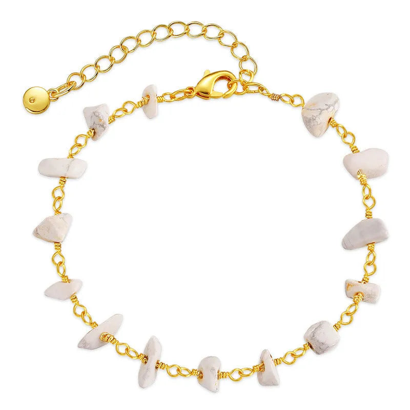 Geometric women's copper bracelet with irregular turquoise gravel stones and crystal accents on a white background.