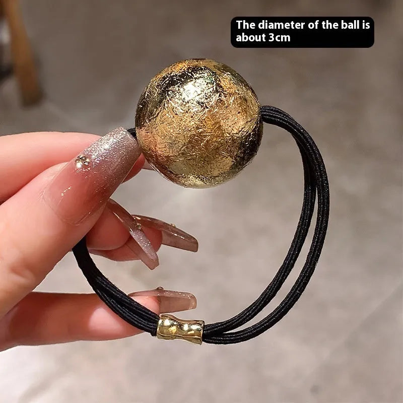 Resin hair band headdress with electroplated gold finish, round head rope style on a white background