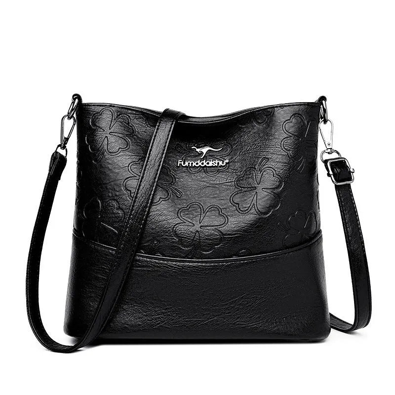 Soft PU leather bucket bag with embossed flower pattern and stitching details in black