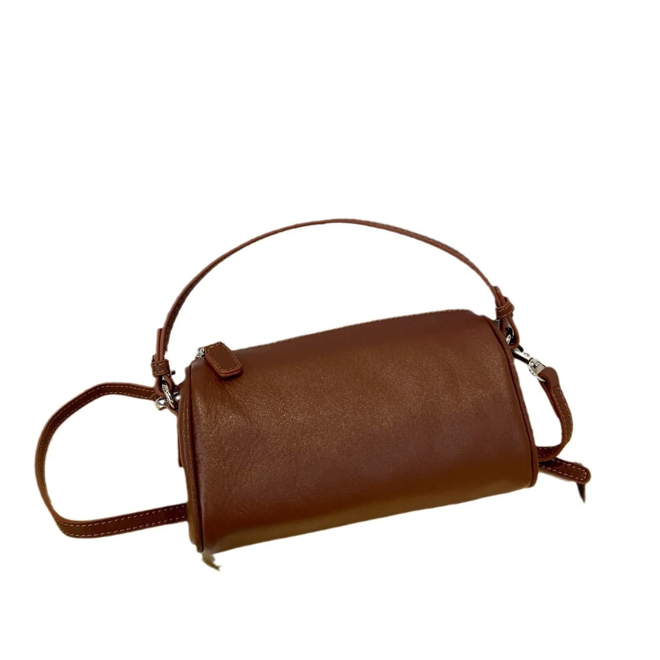 Cylindrical crossbody phone bag in soft genuine leather, shown in one of six colours including black or brown.
