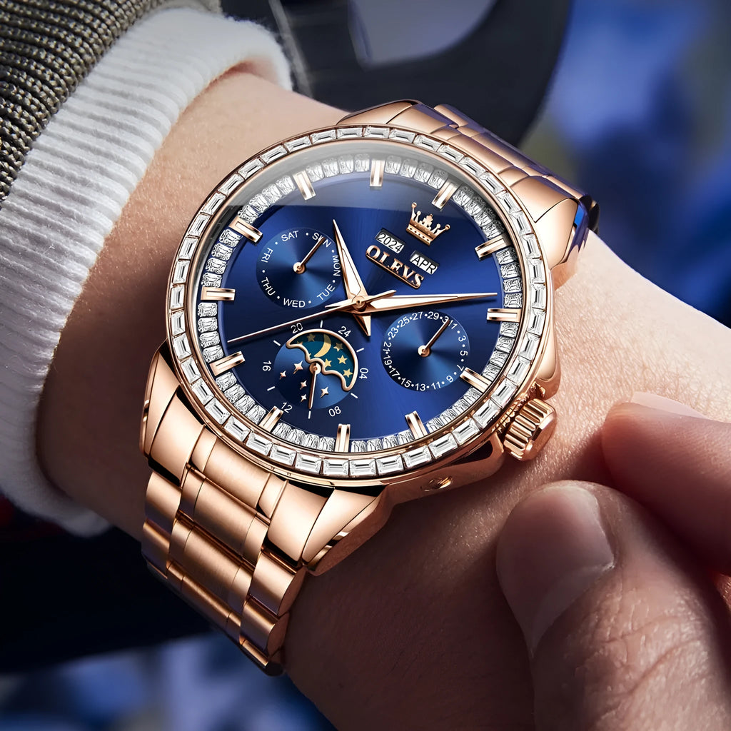 Men's stainless steel automatic mechanical watch with a blue dial and butterfly clasp on a wrist.