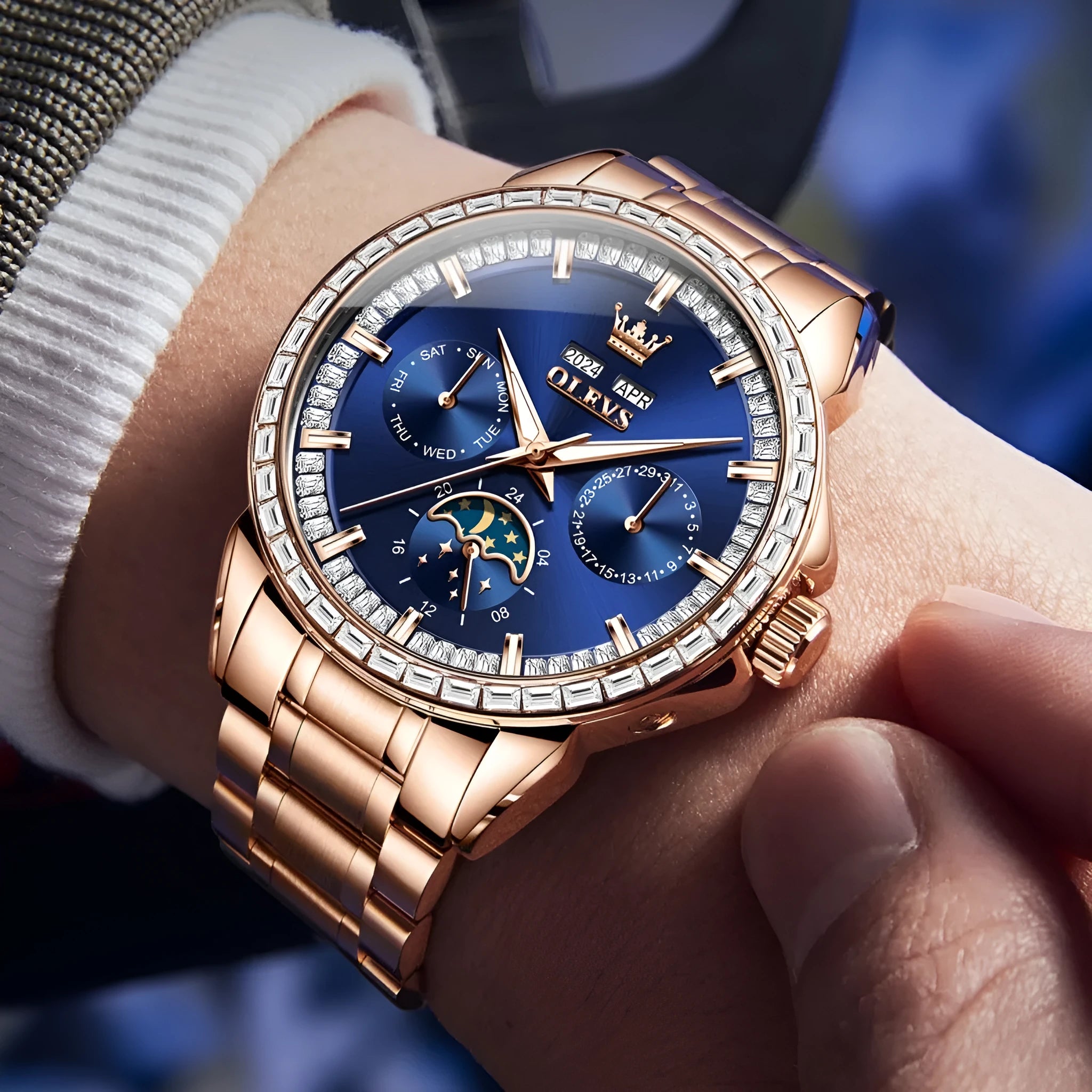 Men's stainless steel automatic mechanical watch with a blue dial and butterfly clasp on a wrist.