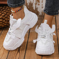Women's platform mesh dad sports trainer in animal print, showing lace-up front and thick sole.