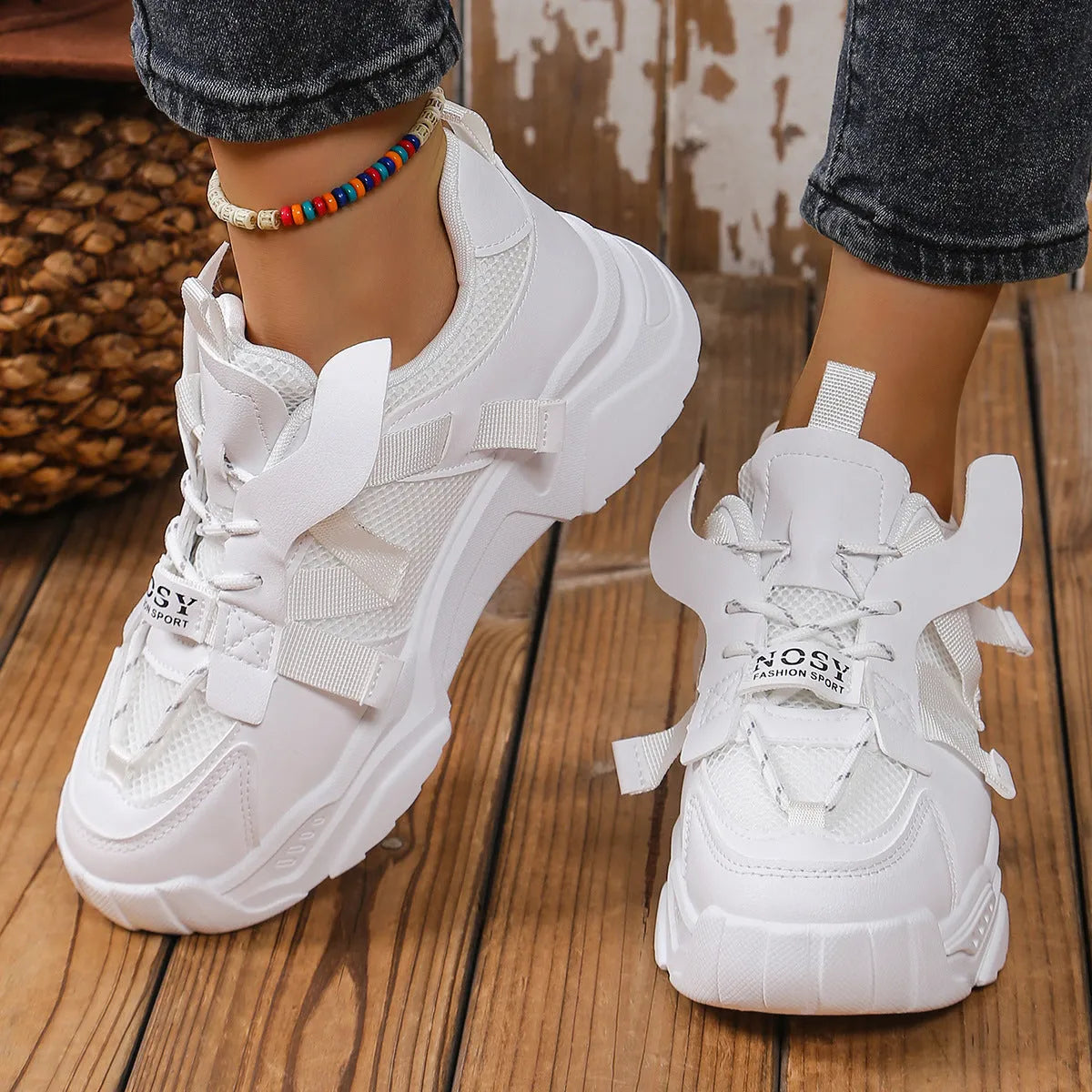 Women's platform mesh dad sports trainer in animal print, showing lace-up front and thick sole.