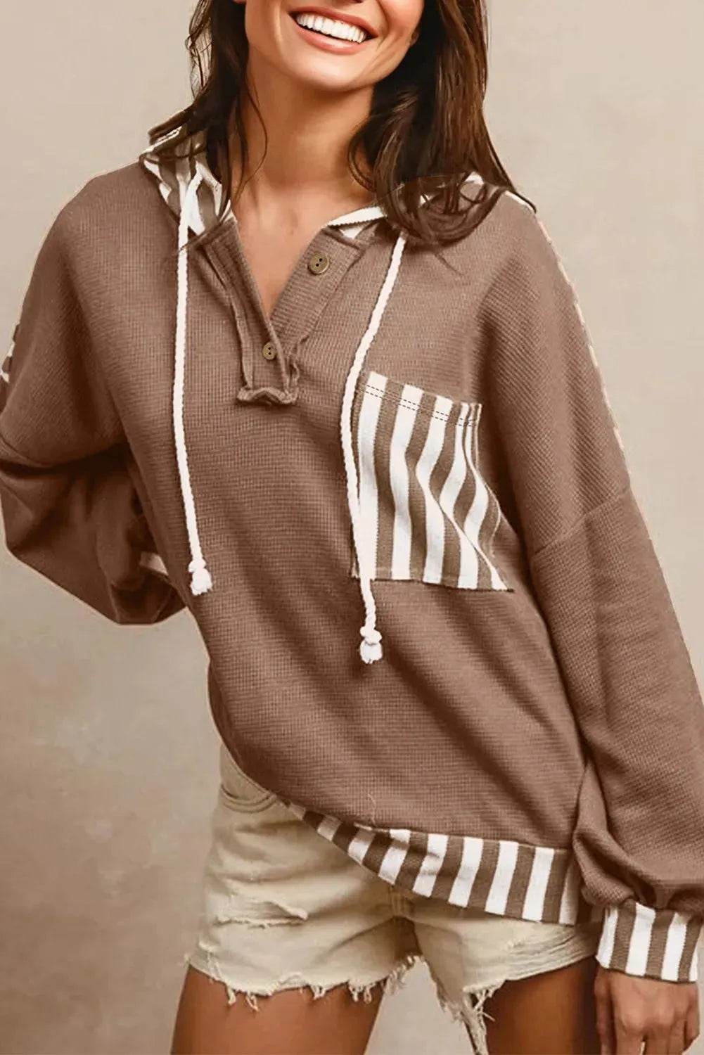 Straw yellow striped patchwork hoodie with waffle texture fabric and a drawstring hood.