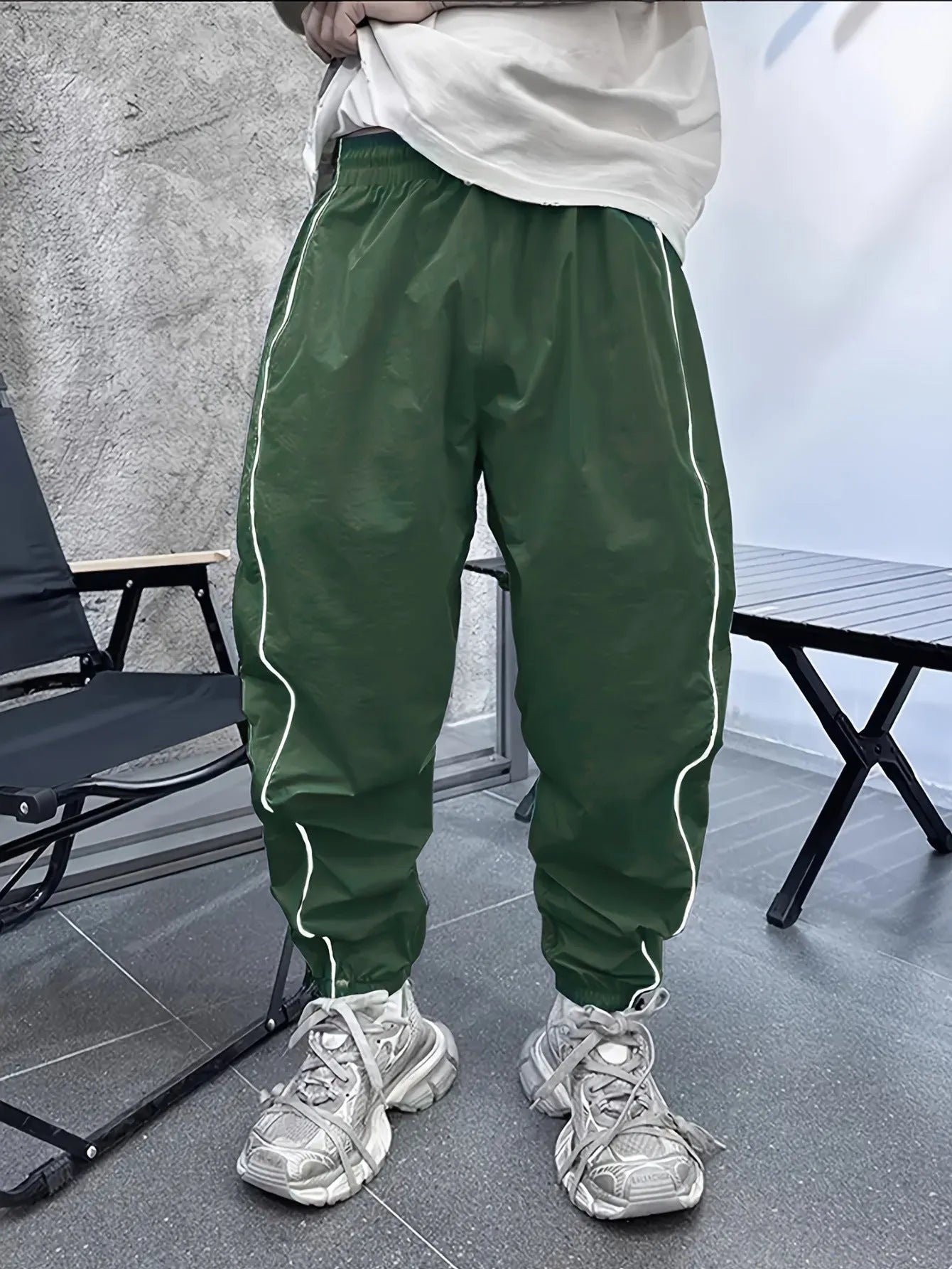 Men's blue bamboo fibre casual sports trousers with a loose, cropped fit on a neutral background.