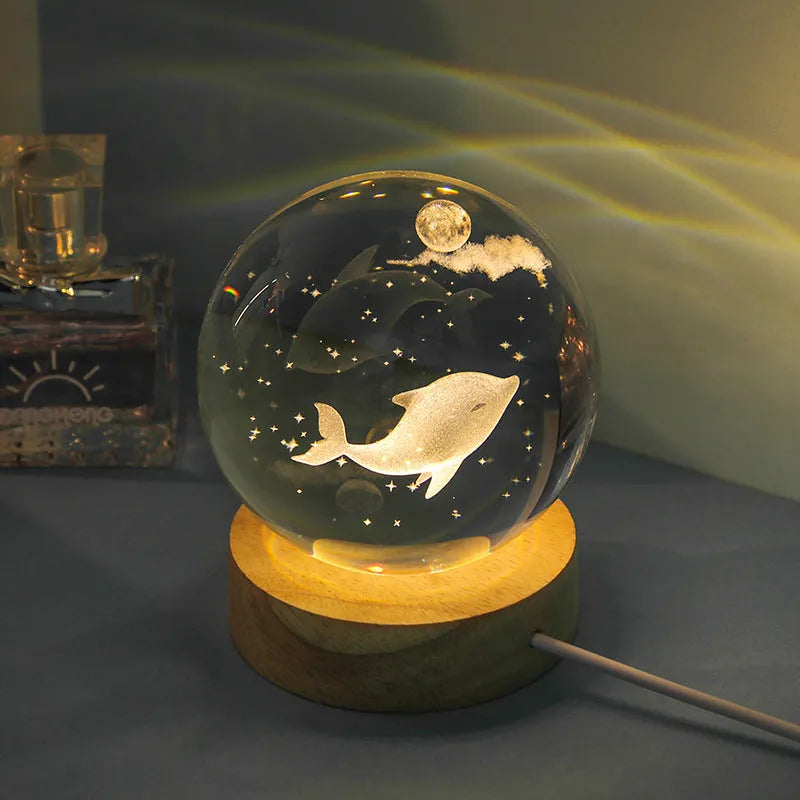 Transparent crystal ball night lamp with 3D carved jellyfish design, on a round base with USB cable.
