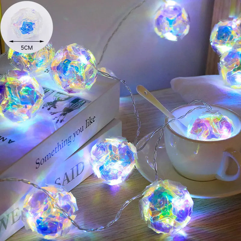 Laser rose windmill LED lamp string with crystal orange light colour on a dark background showing 5cm beads
