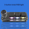 Black and white custom USB macro keyboard with RGB backlighting on a desk
