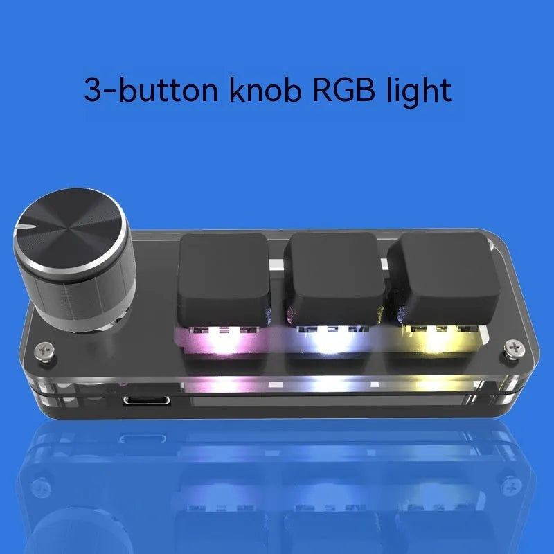 Black and white custom USB macro keyboard with RGB backlighting on a desk
