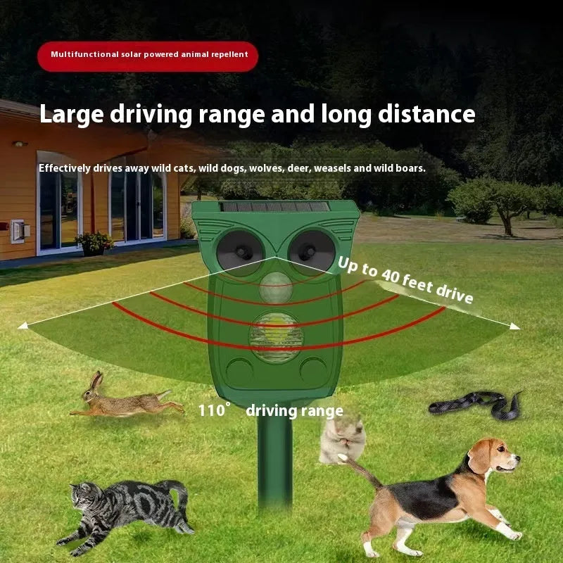 Dark green solar-powered animal repeller with infrared sensor on a garden lawn