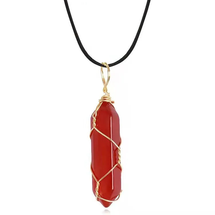 Copper wire winding red crystal hexagonal prism pendant necklace with water wave chain on display