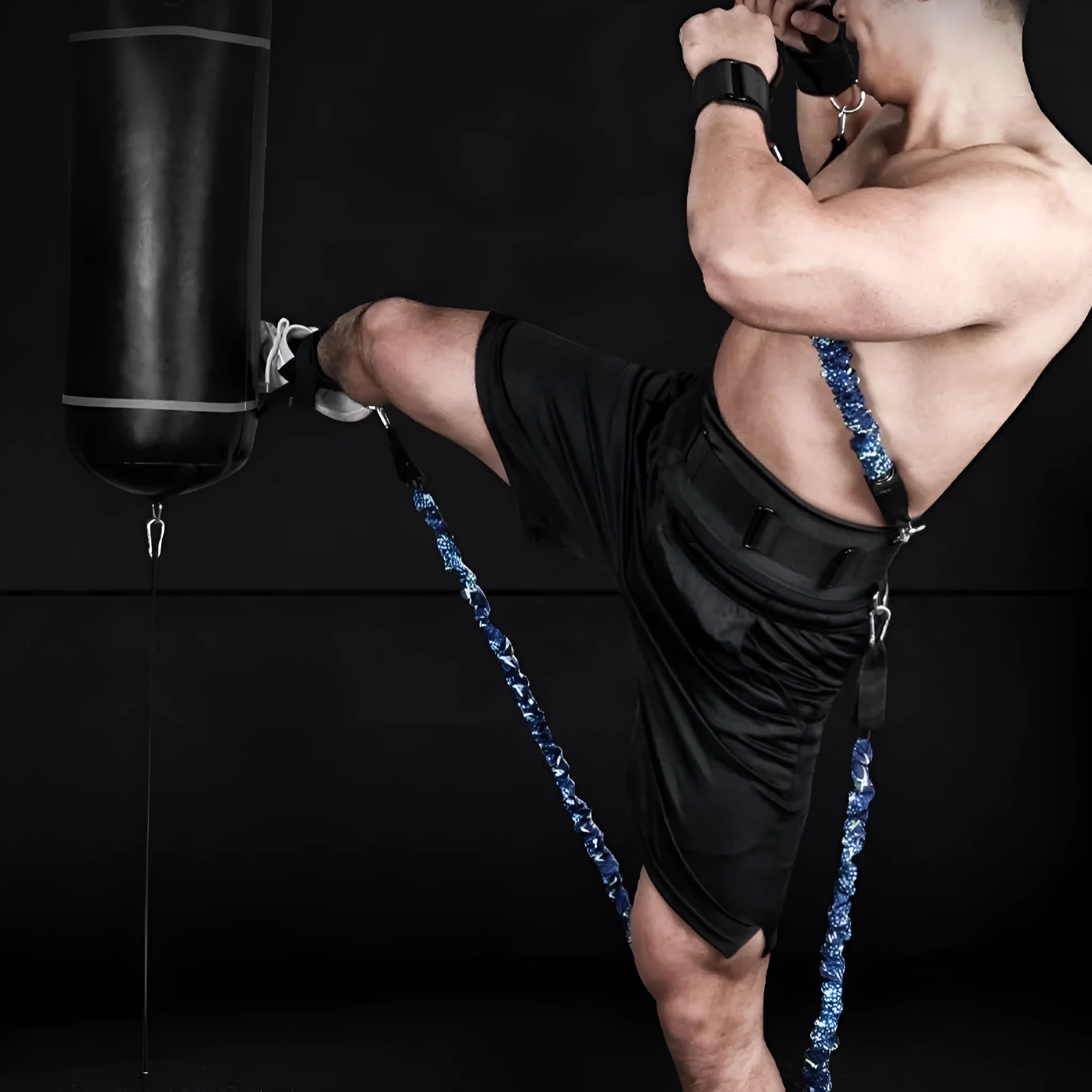 Fitness chest expander elastic belt with red, blue, black, and green resistance sleeves on a grey background.