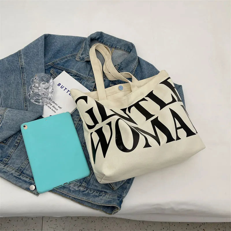 Large capacity canvas tote bag with letter print and upgraded zipper, off-white colour, on plain background