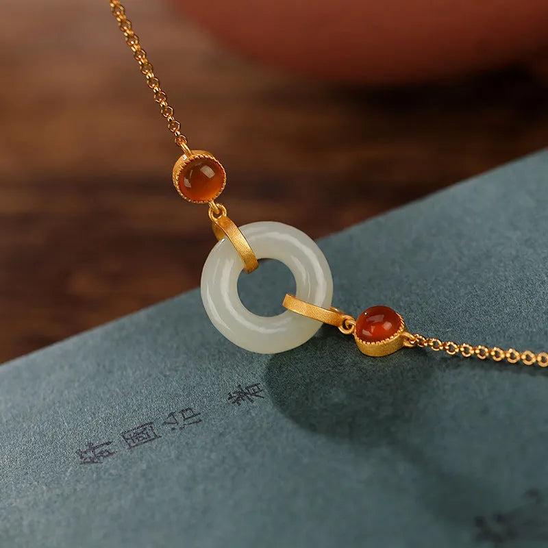Gold-coloured women's bracelet made of S925 sterling silver with a natural Hetian jade peace buckle charm.