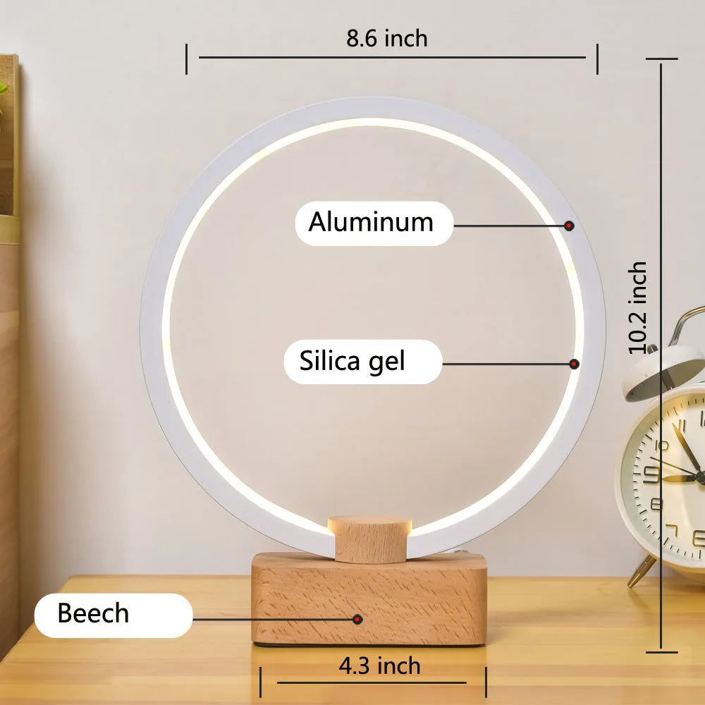 Round small solid wood and bamboo USB-powered LED night lamp on a table.