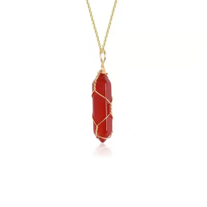 Copper wire winding red crystal hexagonal prism pendant necklace with water wave chain on display